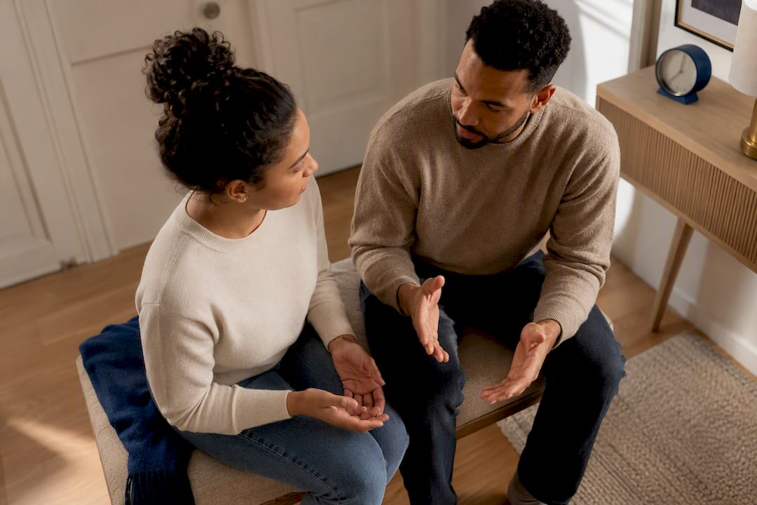 Mixed couple holding weekly conflict check-in